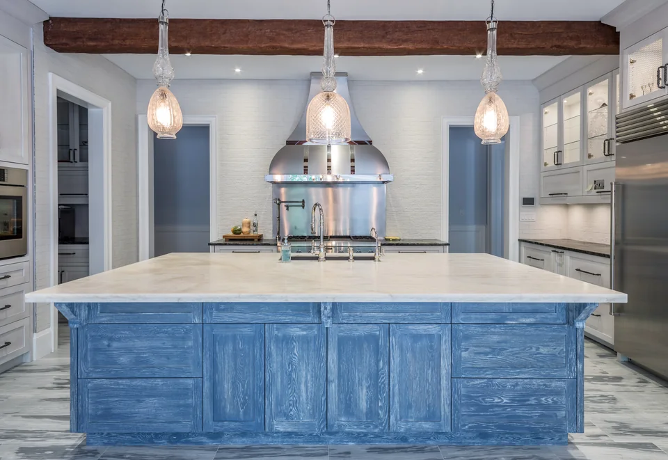 Custom kitchen with a blue island and white perimeter cabinetry