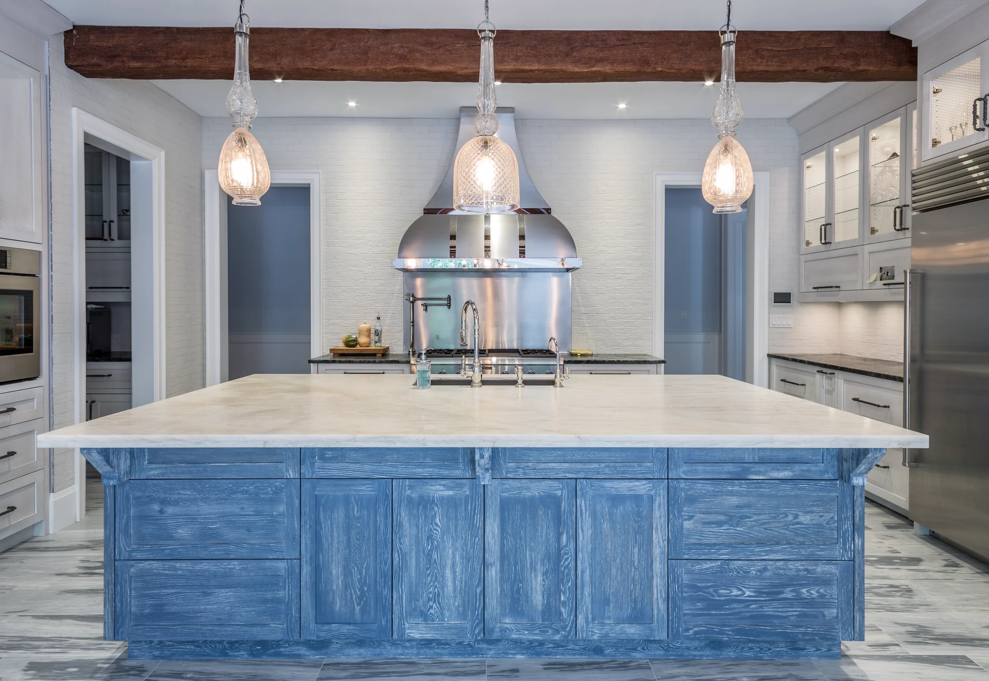 White cabinetry and a blue wood-grain island in a residential kitchen