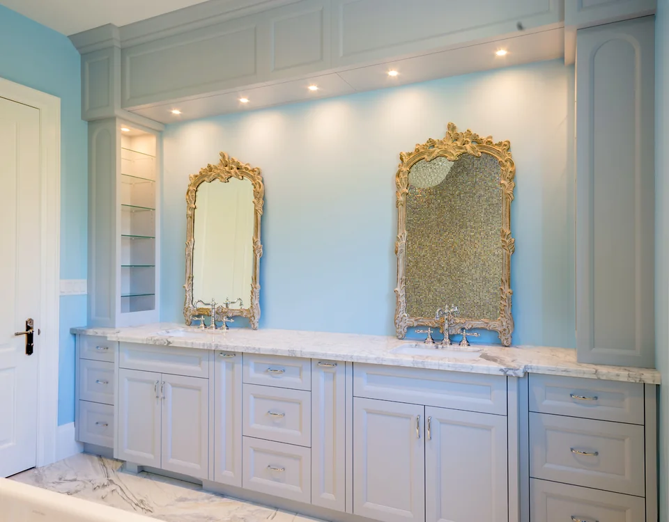 Double vanity with framed cabinetry and two mirrors